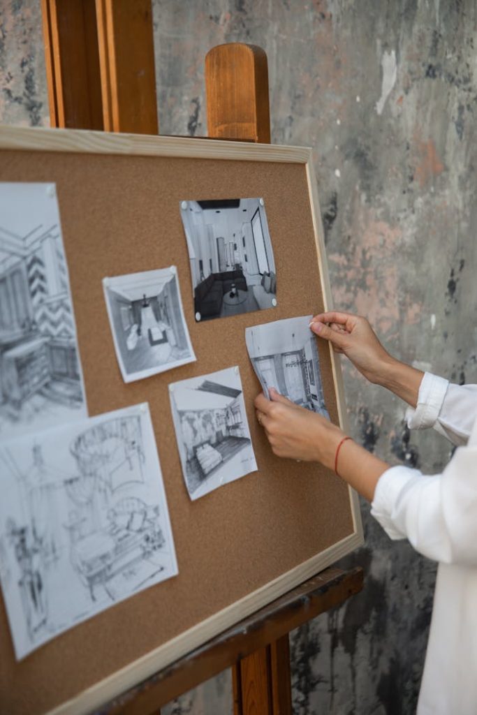 pexels photo 5393600 3 An interior designer setting up sketches on a corkboard in a studio setting.