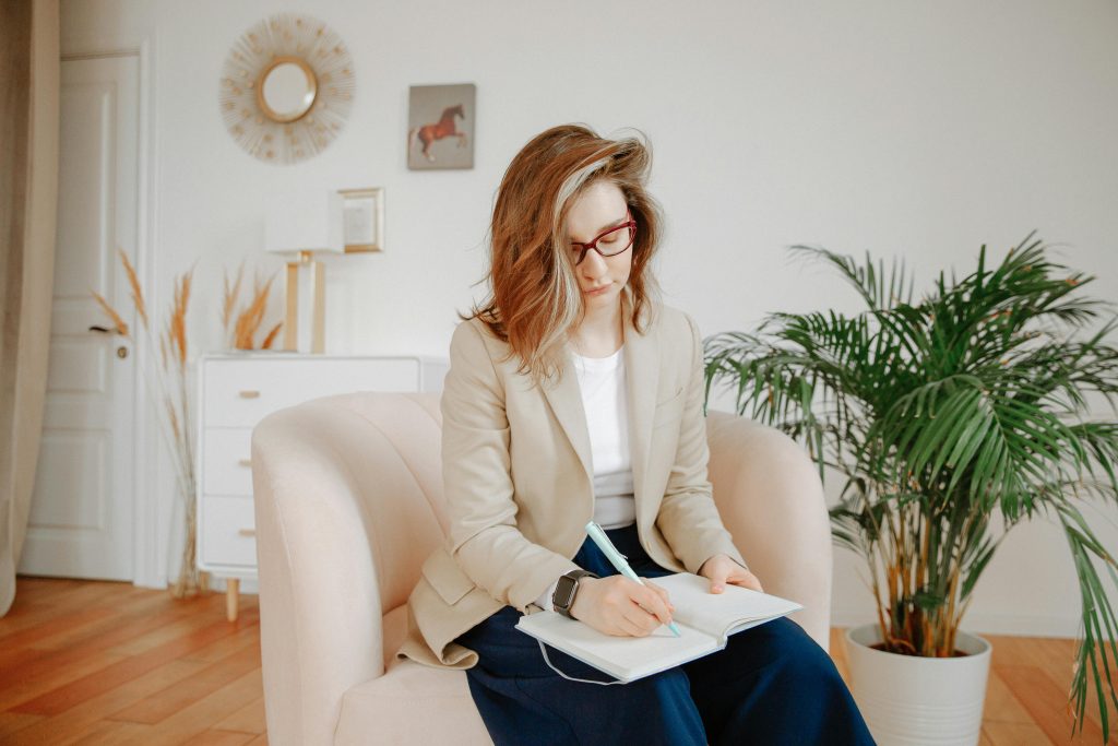 pexels photo 3958402 3958402 A female therapist taking notes during a session in a stylish office setting.